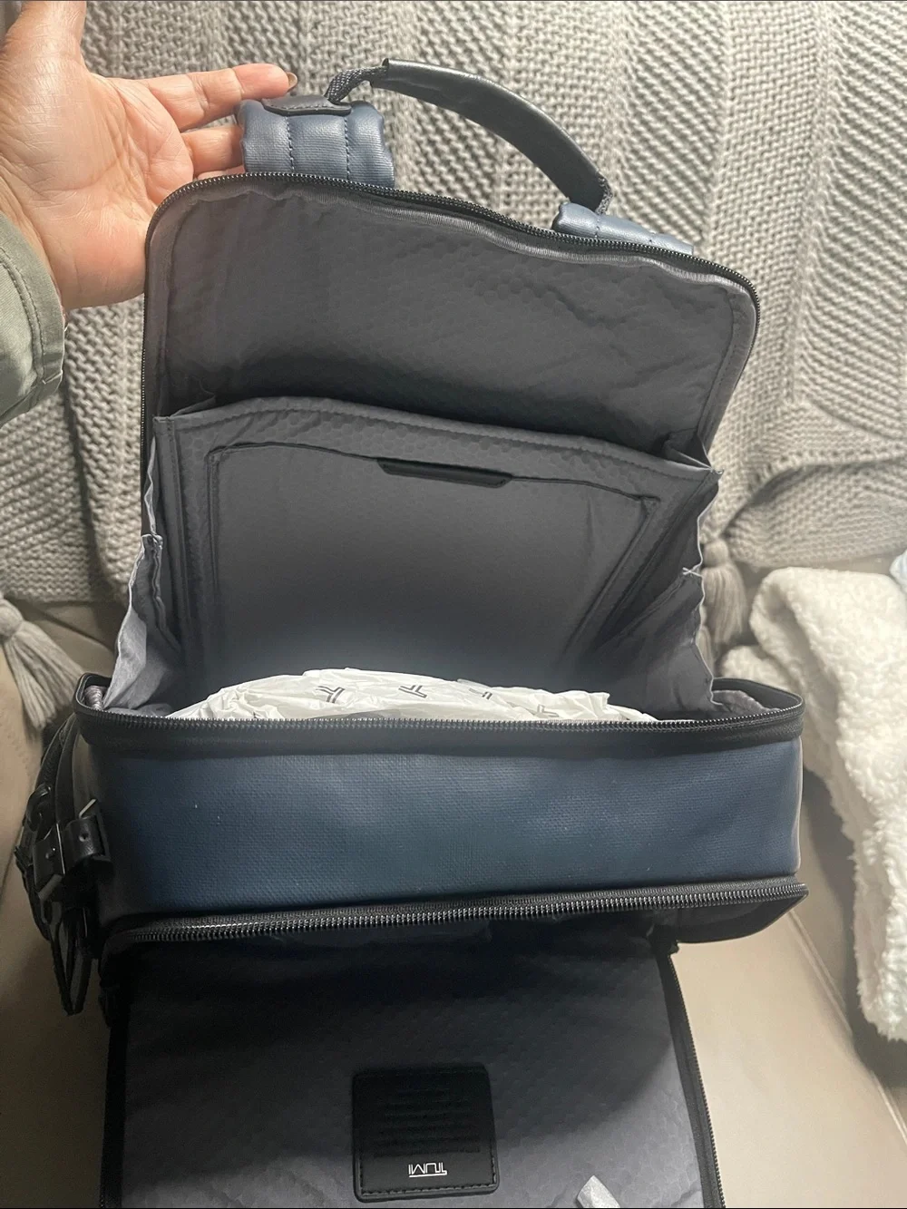 Tumi Men's Blue Travel Backpack with Front Zip Pocket.  It has never been used